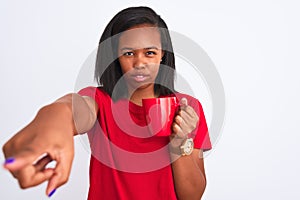 Young african american woman drinking a cup of coffee over isolated background pointing with finger to the camera and to you, hand