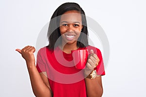 Young african american woman drinking a cup of coffee over isolated background pointing and showing with thumb up to the side with