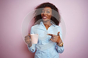 Young african american woman drinking cup of coffee over isolated pink background very happy pointing with hand and finger