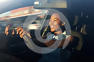 Young african american woman driving a car