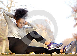 Young african american woman exercising sit ups