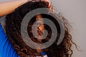 Young african american woman with hair blowing in face