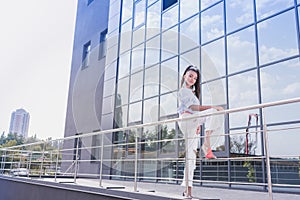 Young african american woman leaning on guardrails