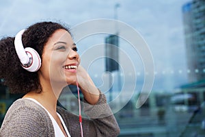 Young african american woman listening to music on headphones