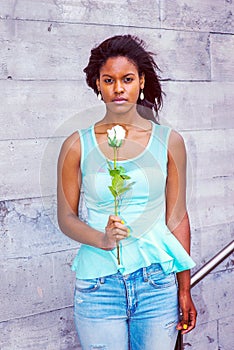 Young African American Woman missing you with white rose in New