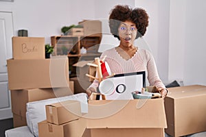 Young african american woman moving to a new home afraid and shocked with surprise and amazed expression, fear and excited face