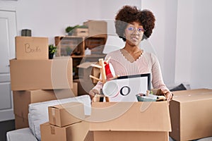 Young african american woman moving to a new home clueless and confused expression