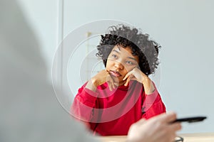 Young african american woman patient and female doctor in doctor office. Girl patient and doctor have consultation in