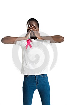 young african american woman with pink ribbon closing eyes with hands