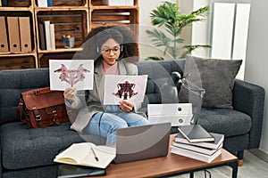 Young african american woman psychologist having teleconsultation doing rorscharch test at psychology center