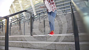 Young african american woman running down stairs, student hurrying to classes