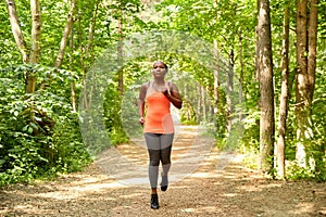 young african american woman running in forest