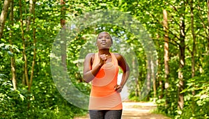 young african american woman running in forest