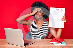 Young african american woman showing a failed exam stressed and frustrated with hand on head, surprised and angry face