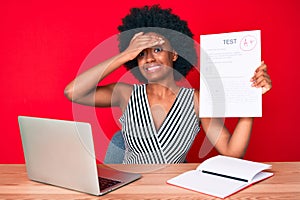 Young african american woman showing a passed exam stressed and frustrated with hand on head, surprised and angry face