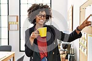 Young african american woman smiling confident drinking coffee at office