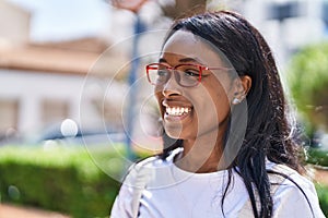 Young african american woman smiling confident wearing glasses at park