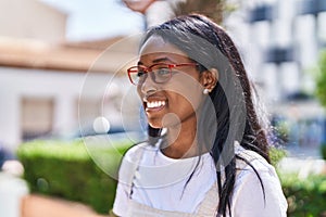 Young african american woman smiling confident wearing glasses at park