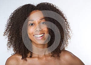 Young african american woman smiling with curly hair