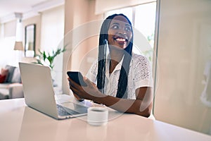 Young african american woman smiling happy working using laptop at home