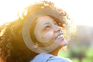 Young african american woman smiling and looking up