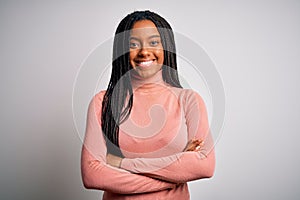 Young african american woman standing casual and cool over white  background happy face smiling with crossed arms looking