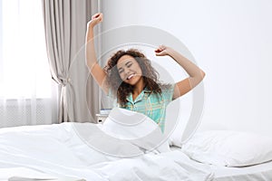 Young African-American woman stretching at home.