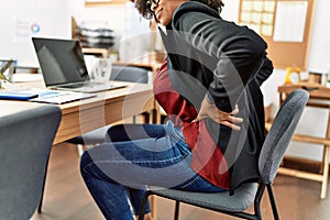 Young african american woman suffering for backache working at office