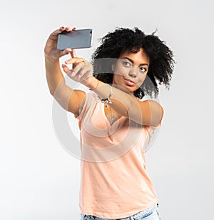 Young African American woman taking a selfie - self portrait - Black teenager people.