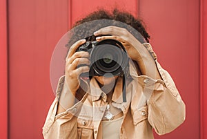 young african american woman using digital camera photo
