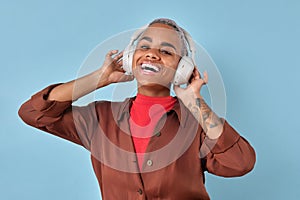 Young African American woman using headphones to listen to educational podcast