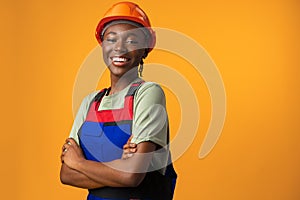 Young african american woman wearing architect hardhat against yellow background