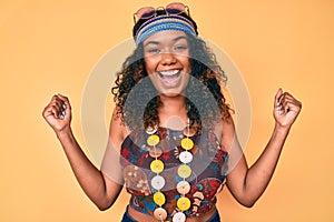 Young african american woman wearing bohemian and hippie style screaming proud, celebrating victory and success very excited with