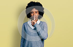 Young african american woman wearing business clothes asking to be quiet with finger on lips