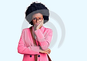 Young african american woman wearing business clothes and leather bag thinking looking tired and bored with depression problems