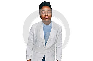 Young african american woman wearing business clothes looking at the camera blowing a kiss on air being lovely and sexy