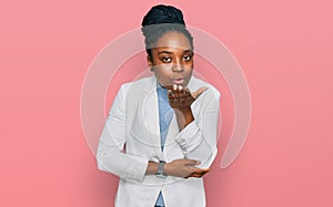 Young african american woman wearing business clothes looking at the camera blowing a kiss with hand on air being lovely and sexy