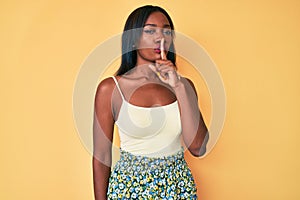 Young african american woman wearing casual clothes asking to be quiet with finger on lips