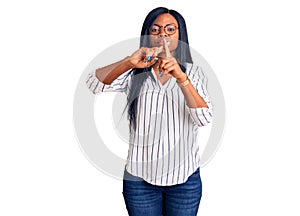 Young african american woman wearing casual clothes and glasses rejection expression crossing fingers doing negative sign