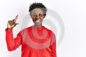 Young african american woman wearing casual clothes over isolated background smiling and confident gesturing with hand doing small