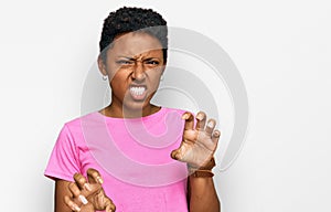 Young african american woman wearing casual clothes smiling funny doing claw gesture as cat, aggressive and sexy expression
