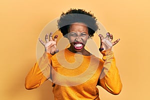 Young african american woman wearing casual clothes smiling funny doing claw gesture as cat, aggressive and sexy expression