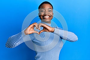 Young african american woman wearing casual clothes smiling in love doing heart symbol shape with hands
