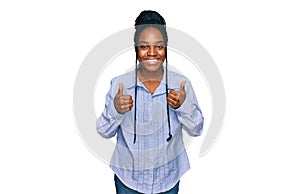 Young african american woman wearing casual clothes success sign doing positive gesture with hand, thumbs up smiling and happy