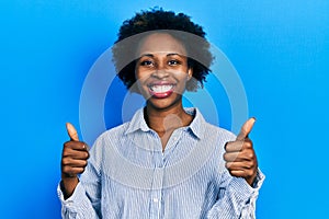 Young african american woman wearing casual clothes success sign doing positive gesture with hand, thumbs up smiling and happy