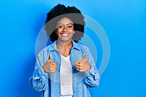 Young african american woman wearing casual clothes success sign doing positive gesture with hand, thumbs up smiling and happy