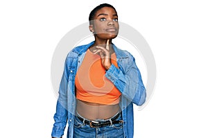 Young african american woman wearing casual clothes thinking concentrated about doubt with finger on chin and looking up wondering