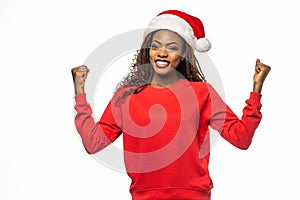 Young african american woman wearing christmas hat over isolated background screaming proud and celebrating victory and success