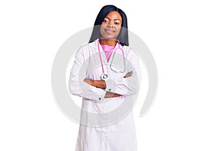 Young african american woman wearing doctor stethoscope happy face smiling with crossed arms looking at the camera