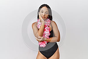 Young african american woman wearing swimsuit and hawaiian lei thinking looking tired and bored with depression problems with